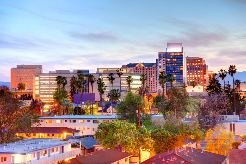 Aerial view of San Jose, California, showcasing a skyline of modern buildings, commercial hubs, and residential areas.