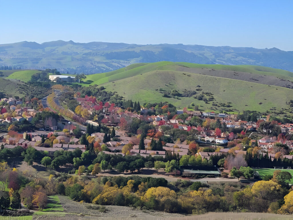 San Ramon, CA aerial view showing suburban homes, green spaces, and real estate opportunities for homebuyers and investors.